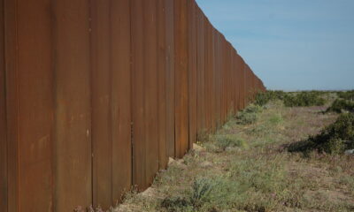 I hope someone tears down The Wall, US border, separating Mexico from the US, looking east, along Highway 2, Sonora Desert, Mexican side