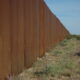 I hope someone tears down The Wall, US border, separating Mexico from the US, looking east, along Highway 2, Sonora Desert, Mexican side